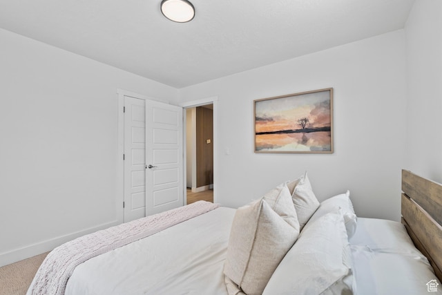 bedroom with light carpet and a closet