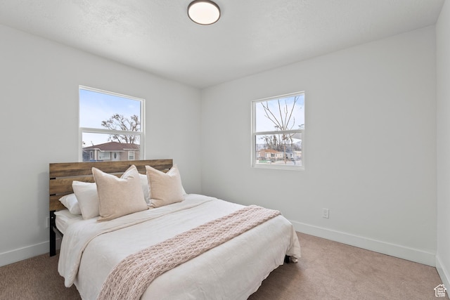 bedroom with carpet flooring and multiple windows