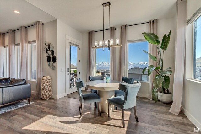 14203 S Brook Heights Cir W, Herriman, UT 84096 - dining area with a chandelier, a mountain view, and hardwood / wood-style floors