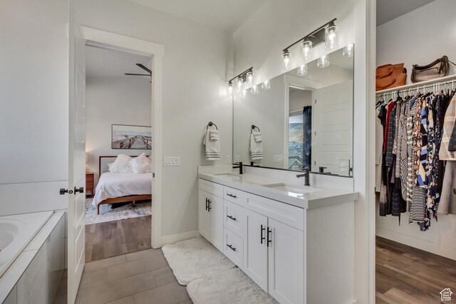 14203 S Brook Heights Cir W, Herriman, UT 84096 - bathroom with vanity, a tub, and wood-type flooring
