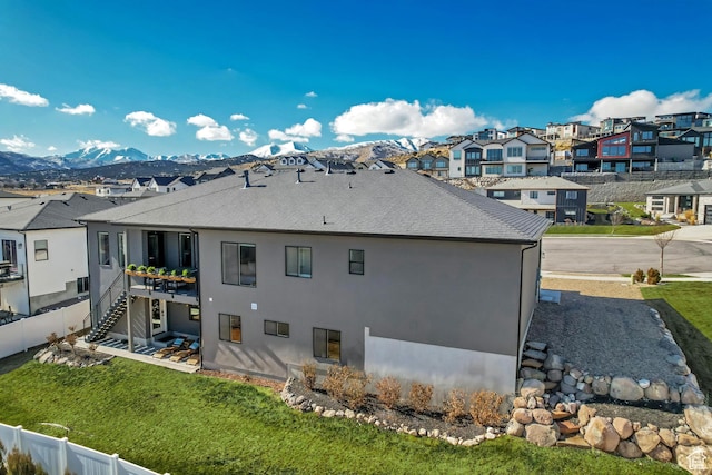 14203 S Brook Heights Cir W, Herriman, UT 84096 - rear view of house with a mountain view and a lawn