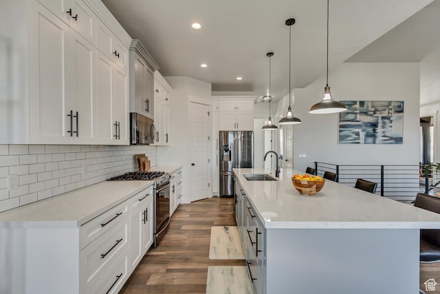 14203 S Brook Heights Cir W, Herriman, UT 84096 - kitchen featuring white cabinetry, stainless steel appliances, decorative light fixtures, and a center island with sink
