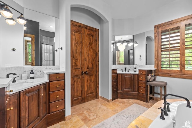 bathroom with vanity and a bathing tub