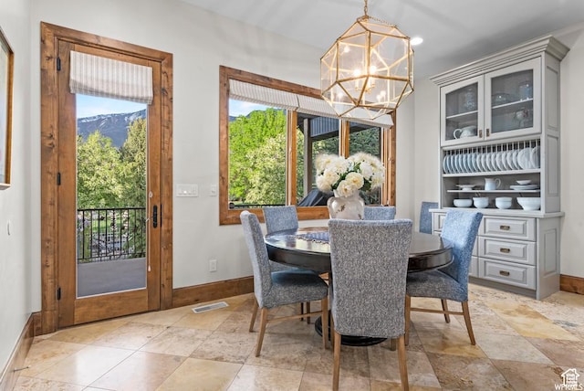dining room featuring a notable chandelier and a mountain view