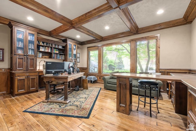office space with coffered ceiling, beam ceiling, light hardwood / wood-style floors, and crown molding