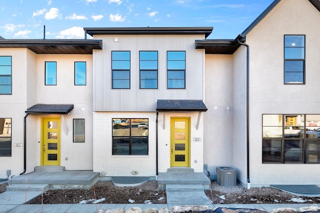 townhome / multi-family property featuring central AC unit