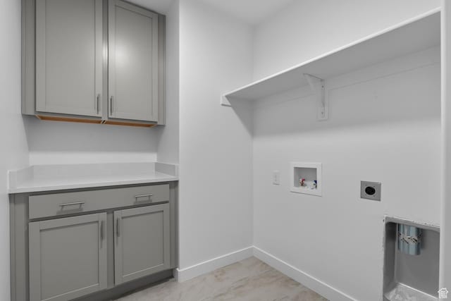 laundry area with cabinets, hookup for a washing machine, and electric dryer hookup