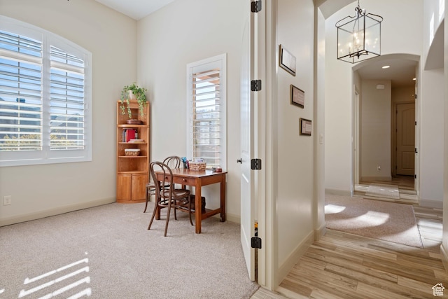 corridor with an inviting chandelier