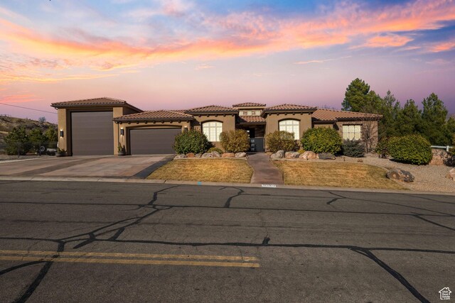 mediterranean / spanish-style home with a garage