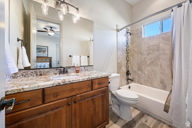full bathroom with ceiling fan, vanity, wood-type flooring, toilet, and shower / bath combo with shower curtain
