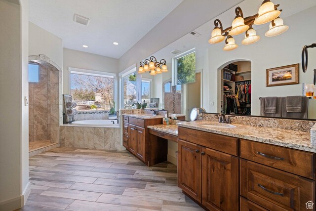 1512 Cholla Dr, Toquerville, UT 84774 - bathroom featuring a bath, vanity, a stall shower, wood finished floors, and a walk in closet