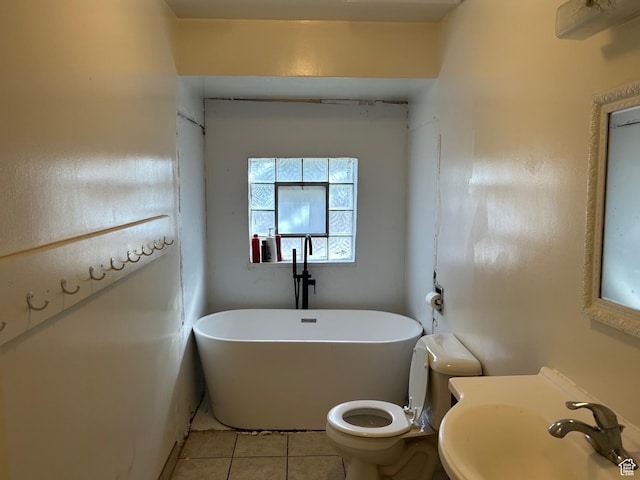 bathroom with sink, toilet, a washtub, and tile patterned flooring