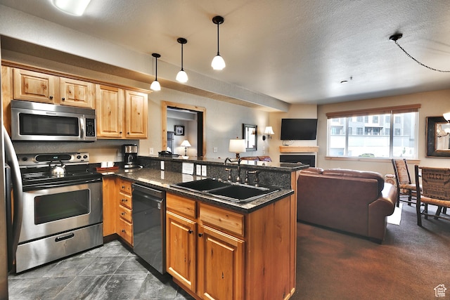 2669 N Canyons Resort Dr W Unit 205, Park City, UT 84098 - kitchen featuring appliances with stainless steel finishes, open floor plan, a peninsula, hanging light fixtures, and a sink
