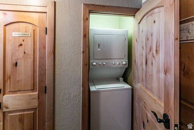 2669 N Canyons Resort Dr W Unit 205, Park City, UT 84098 - laundry room with stacked washing maching and dryer, laundry area, and a textured wall