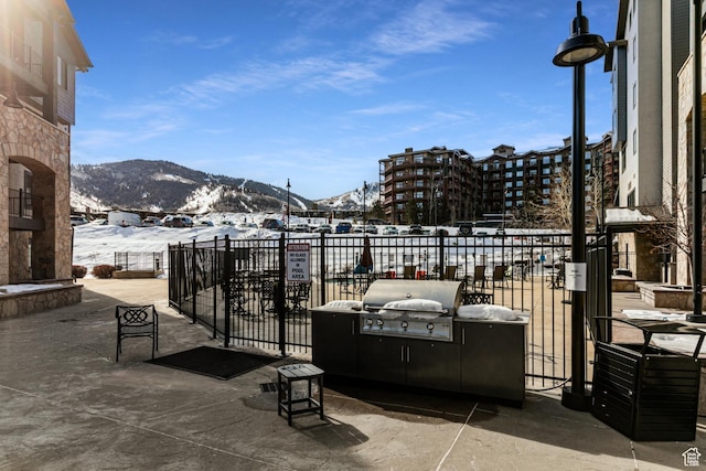 2669 N Canyons Resort Dr W Unit 205, Park City, UT 84098 - snow covered patio featuring a mountain view, area for grilling, and fence