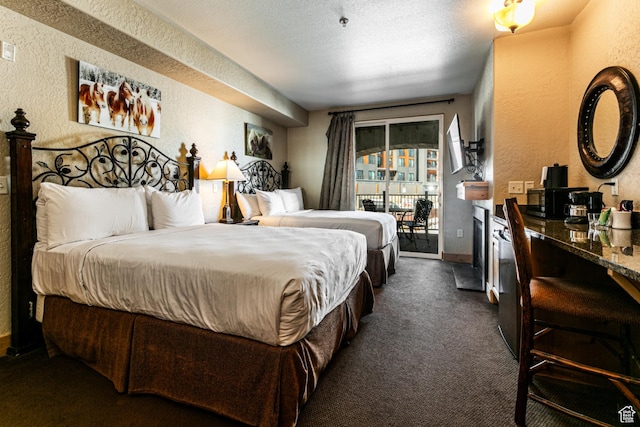 2669 N Canyons Resort Dr W Unit 205, Park City, UT 84098 - bedroom with access to exterior, dark carpet, a textured wall, a textured ceiling, and baseboards