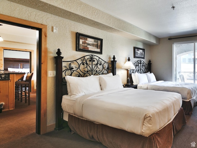 2669 N Canyons Resort Dr W Unit 205, Park City, UT 84098 - bedroom with a textured ceiling, a textured wall, and dark colored carpet