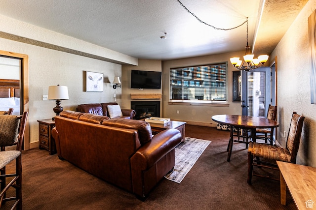2669 N Canyons Resort Dr W Unit 205, Park City, UT 84098 - living room featuring baseboards, a textured wall, dark colored carpet, a textured ceiling, and a notable chandelier