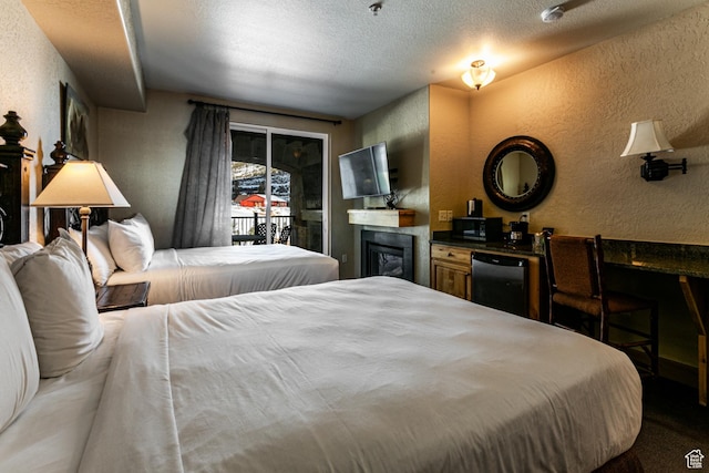 2669 N Canyons Resort Dr W Unit 205, Park City, UT 84098 - bedroom with access to outside, a glass covered fireplace, a textured wall, and a textured ceiling
