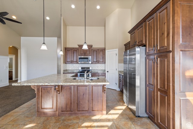 11513 S Jackson Downs Way S, Jordan, UT 84095 - kitchen with a breakfast bar, sink, tasteful backsplash, hanging light fixtures, and stainless steel appliances