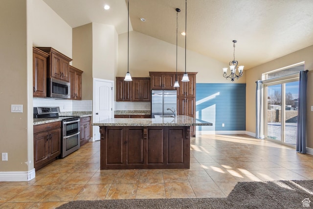 11513 S Jackson Downs Way S, Jordan, UT 84095 - kitchen with sink, light stone counters, hanging light fixtures, stainless steel appliances, and a kitchen island with sink