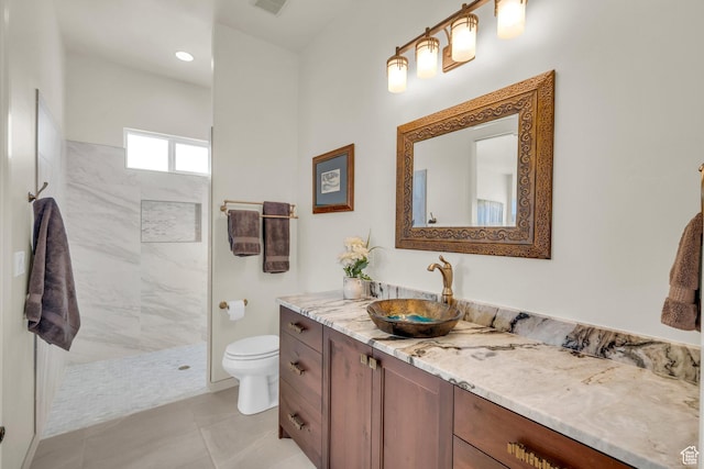 full bath with a walk in shower, vanity, tile patterned flooring, visible vents, and toilet