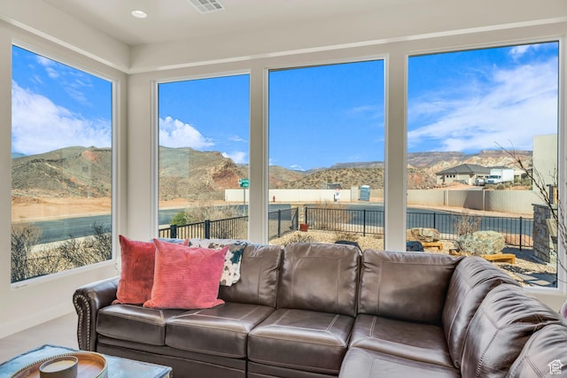 sunroom / solarium featuring a mountain view and visible vents