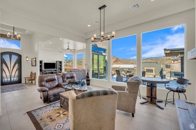 living room with visible vents, recessed lighting, tile patterned flooring, and ceiling fan with notable chandelier