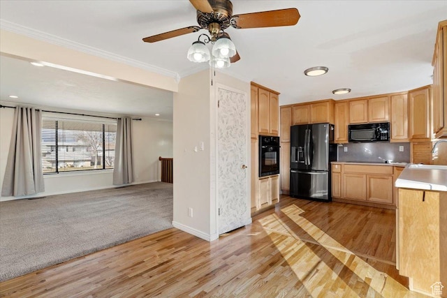 kitchen with light brown cabinetry, black appliances, light hardwood / wood-style flooring, ornamental molding, and backsplash
