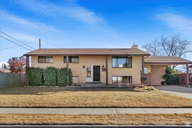raised ranch with a carport and a front lawn
