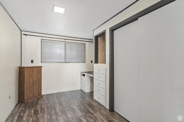 interior space with dark wood-type flooring and a closet