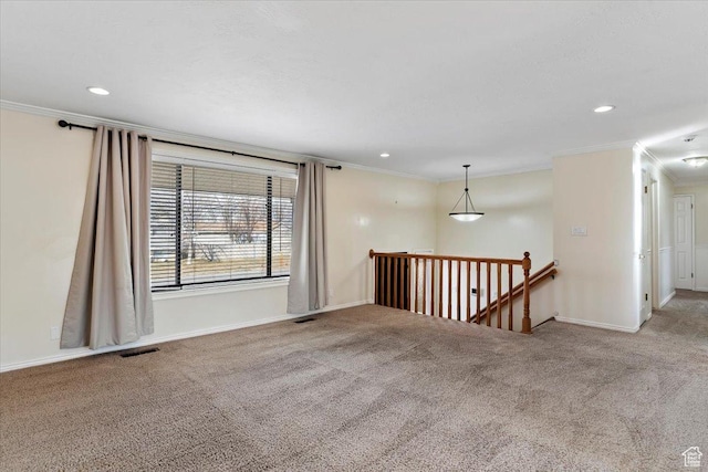carpeted spare room featuring ornamental molding