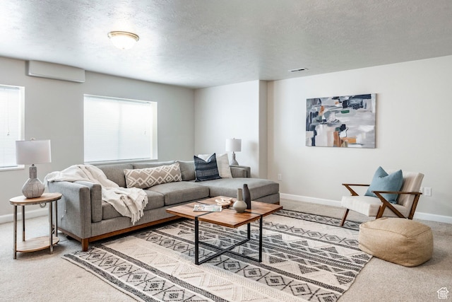 living room featuring a textured ceiling, carpet floors, a wall mounted AC, and plenty of natural light