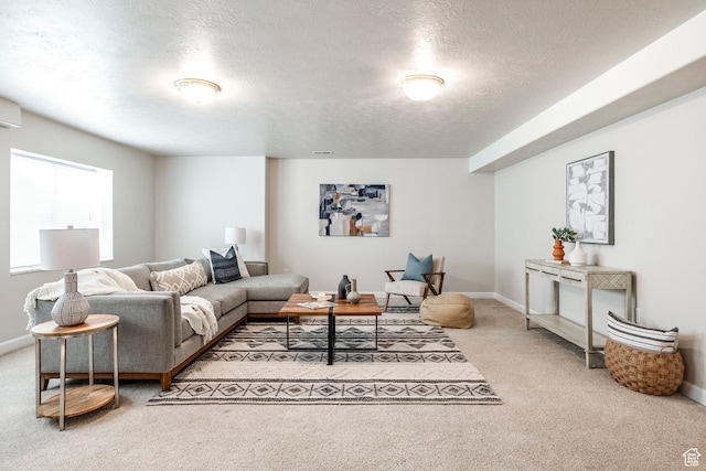 carpeted living room featuring a textured ceiling and a wall unit AC