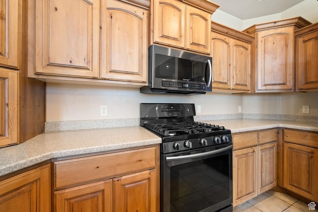 3523 S Desert Hills Dr, St George, UT 84790 - kitchen with light countertops, light tile patterned floors, and black range with gas stovetop