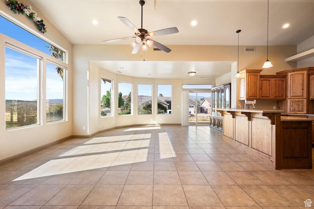 3523 S Desert Hills Dr, St George, UT 84790 - kitchen with plenty of natural light, open floor plan, a breakfast bar, and light tile patterned floors