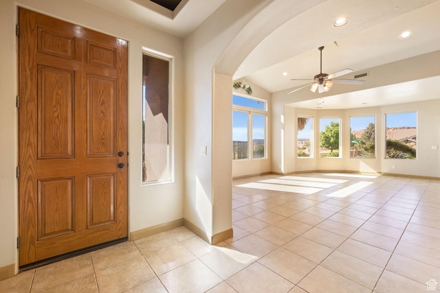 3523 S Desert Hills Dr, St George, UT 84790 - foyer with baseboards, light tile patterned floors, lofted ceiling, arched walkways, and ceiling fan