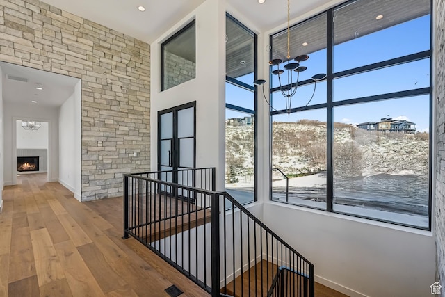 2738 Longspur Ln, Park City, UT 84098 - corridor featuring a notable chandelier, hardwood / wood-style flooring, and a high ceiling