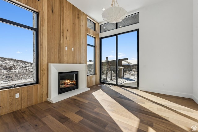 2738 Longspur Ln, Park City, UT 84098 - unfurnished living room with a high ceiling, dark wood-type flooring, and wooden walls