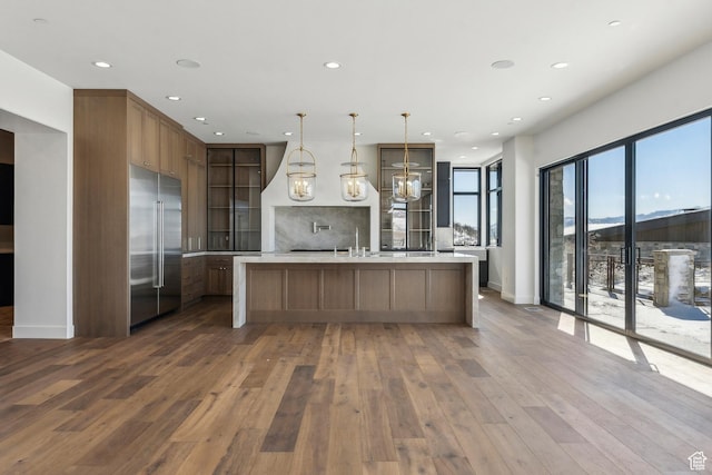 2738 Longspur Ln, Park City, UT 84098 - kitchen featuring dark wood-type flooring, a spacious island, decorative light fixtures, stainless steel built in fridge, and a mountain view