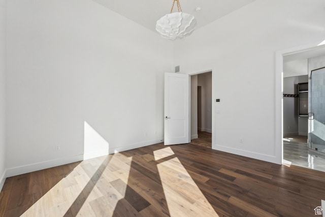 2738 Longspur Ln, Park City, UT 84098 - unfurnished bedroom featuring dark hardwood / wood-style floors, a chandelier, and a high ceiling