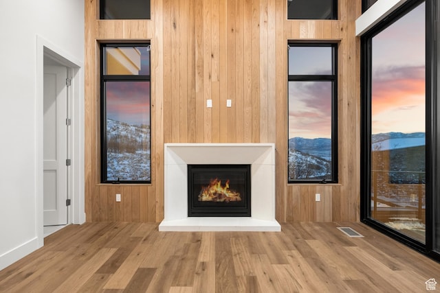 2738 Longspur Ln, Park City, UT 84098 - unfurnished living room with wooden walls, a mountain view, and hardwood / wood-style floors