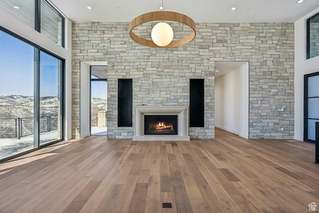 2738 Longspur Ln, Park City, UT 84098 - unfurnished living room featuring wood-type flooring and a stone fireplace