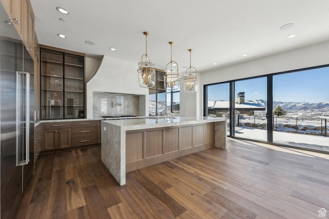 2738 Longspur Ln, Park City, UT 84098 - kitchen featuring dark wood-type flooring, hanging light fixtures, an island with sink, a mountain view, and high end refrigerator