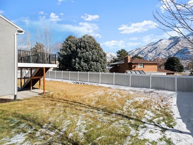 view of yard featuring a deck with mountain view