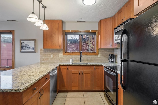 236 Norfolk Ave, Park City, UT 84060 - kitchen with light stone counters, sink, black appliances, and kitchen peninsula