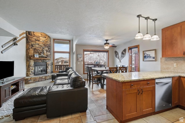 236 Norfolk Ave, Park City, UT 84060 - kitchen with hanging light fixtures, light stone countertops, backsplash, and kitchen peninsula