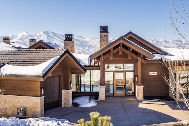 9791 N Uinta Dr, Kamas, UT 84036 - chalet / cabin featuring stone siding, a mountain view, and a chimney