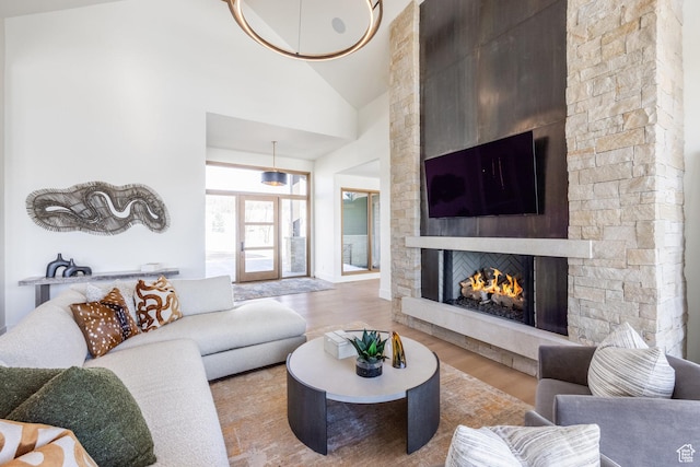 9791 N Uinta Dr, Kamas, UT 84036 - living room featuring a stone fireplace, high vaulted ceiling, and wood finished floors
