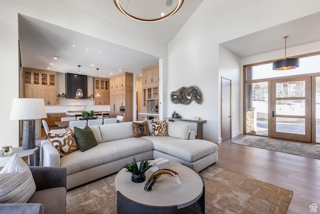 9791 N Uinta Dr, Kamas, UT 84036 - living room featuring baseboards, a high ceiling, wood finished floors, and recessed lighting